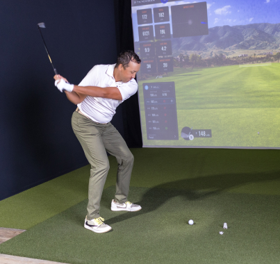 Man playing golf at Fairway Golf simulator facility in San Antonio
