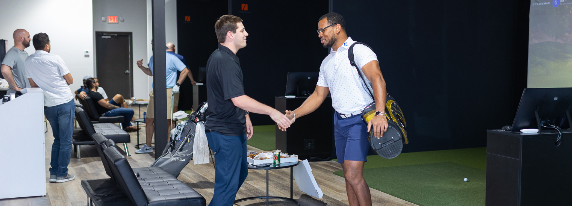 Fairway Golf simulator facility in San Antonio client and worker shaking hands