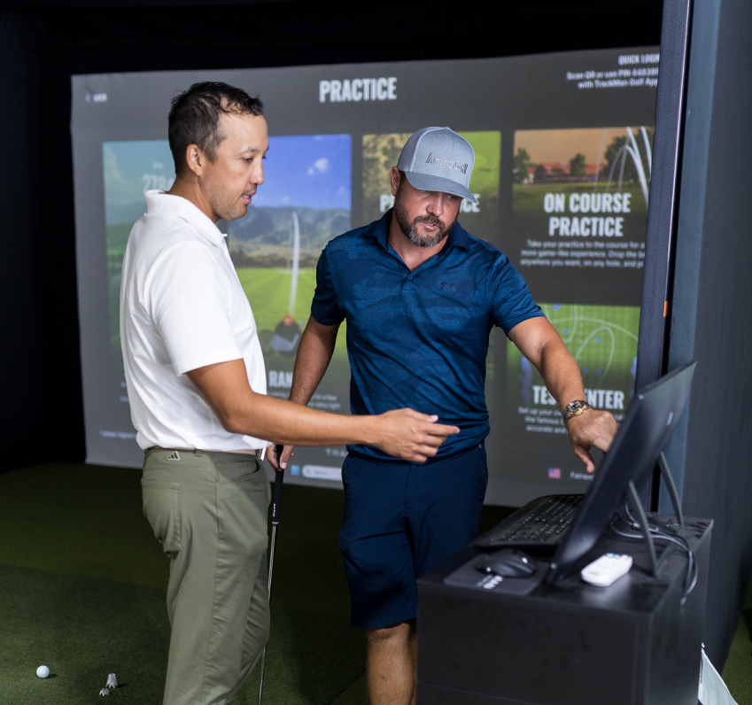 Fairway Golf Simulator man with instructor checking screen and tracker