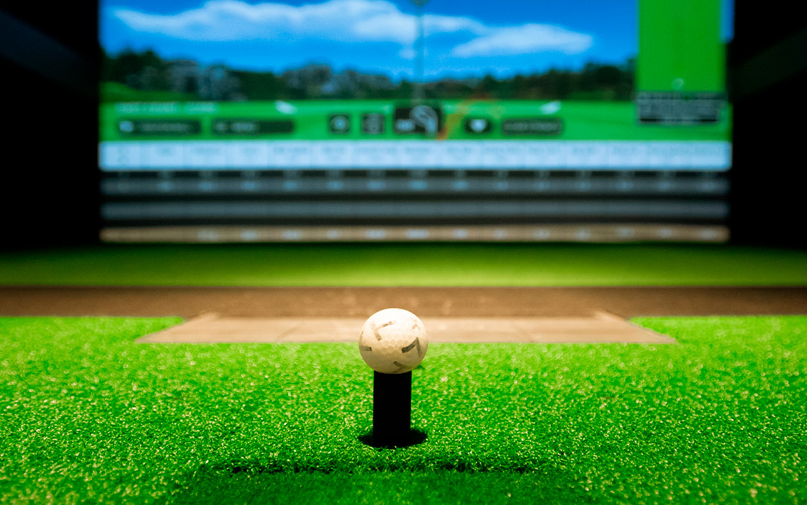 Golf ball on tee at simulator