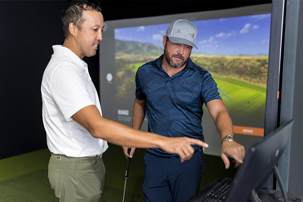 instructor with golfer in Fairway