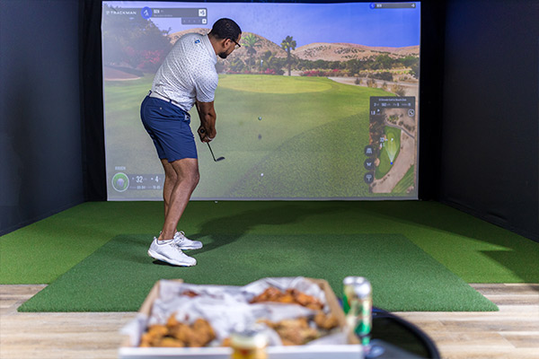 indoor golf: person playing in front of food.