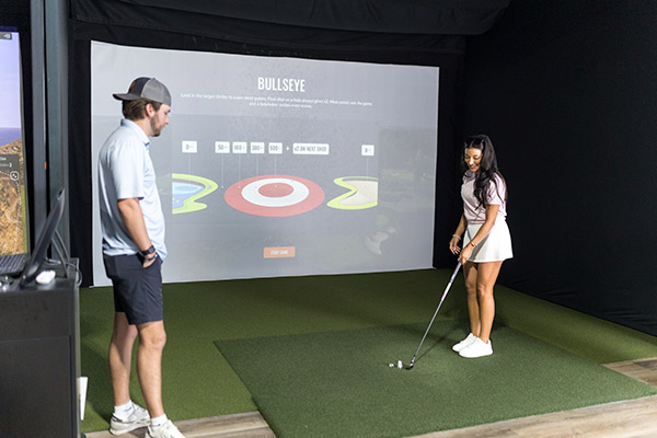 couple at Fairway gol simulator