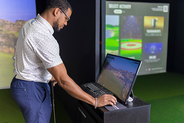 Computer screen displays a man playing golf, highlighting Trackman technology for game improvement in San Antonio.