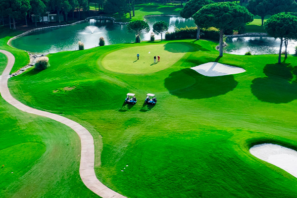 A picturesque golf course with vibrant green grass and a serene water feature, perfect for novice players in San Antonio.