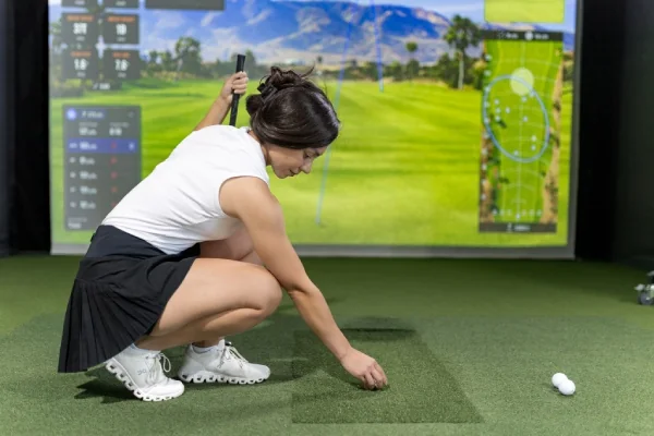 Woman at indoor golf Fairway 