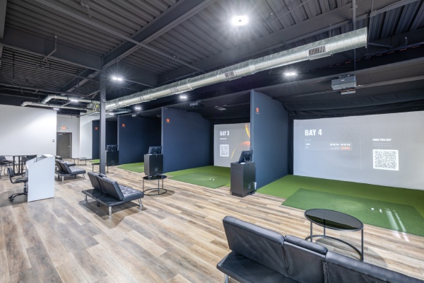 Interior view of the golf simulator at the new city golf club, showcasing advanced technology for virtual golfing experiences.