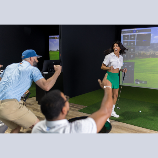 A woman in a golf outfit celebrates while holding a golf club, with excited friends cheering in a virtual golf setting.